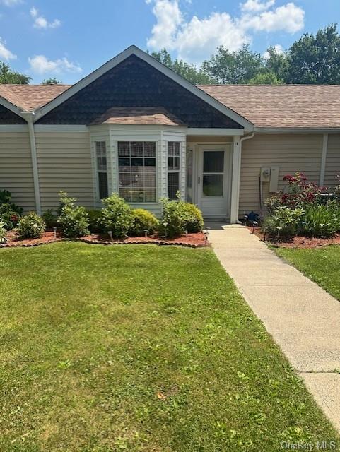 Ranch-style home featuring a front lawn