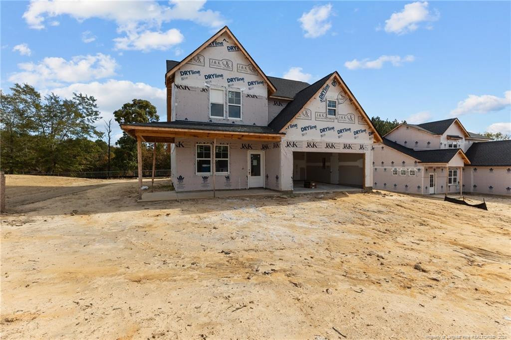 a view of a house with large windows and a yard