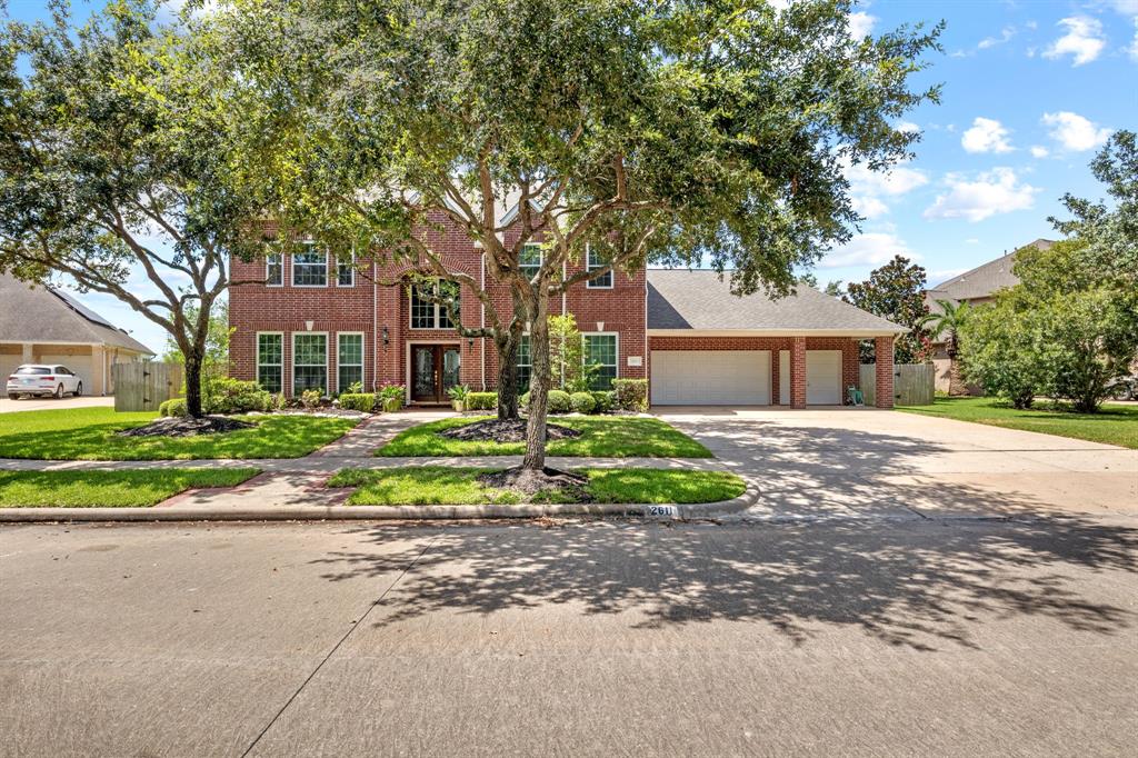 a front view of a house with a yard and a garage