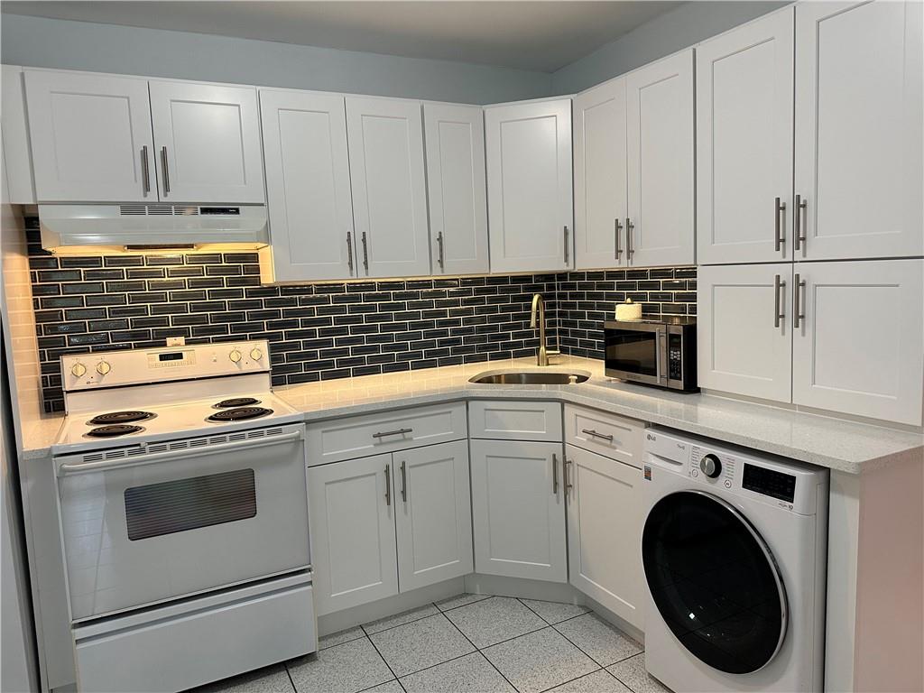 a kitchen with white cabinets and white appliances