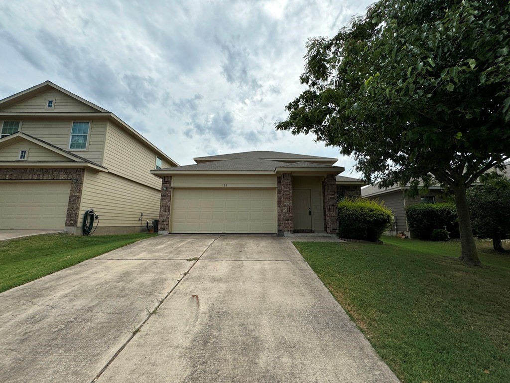 a front view of house with yard and green space