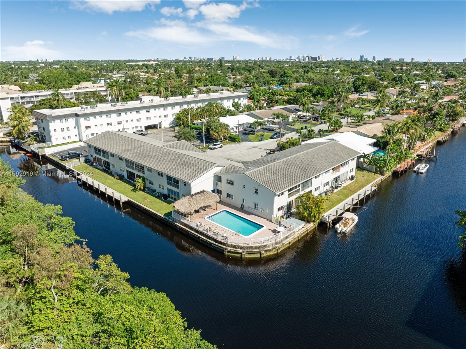 an aerial view of residential houses with outdoor space and river