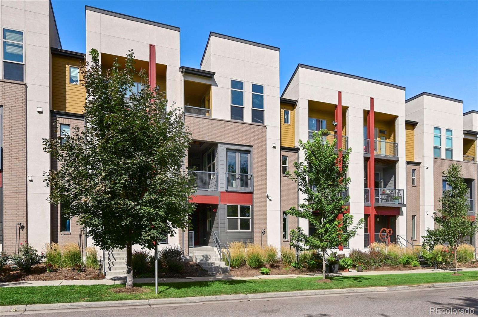 a front view of a residential apartment building with a yard