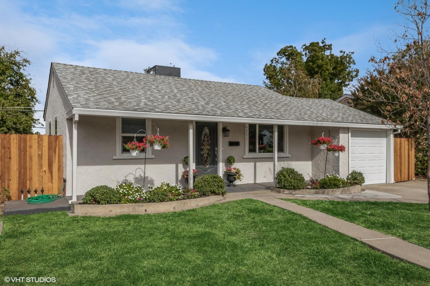 a front view of a house with a yard and porch