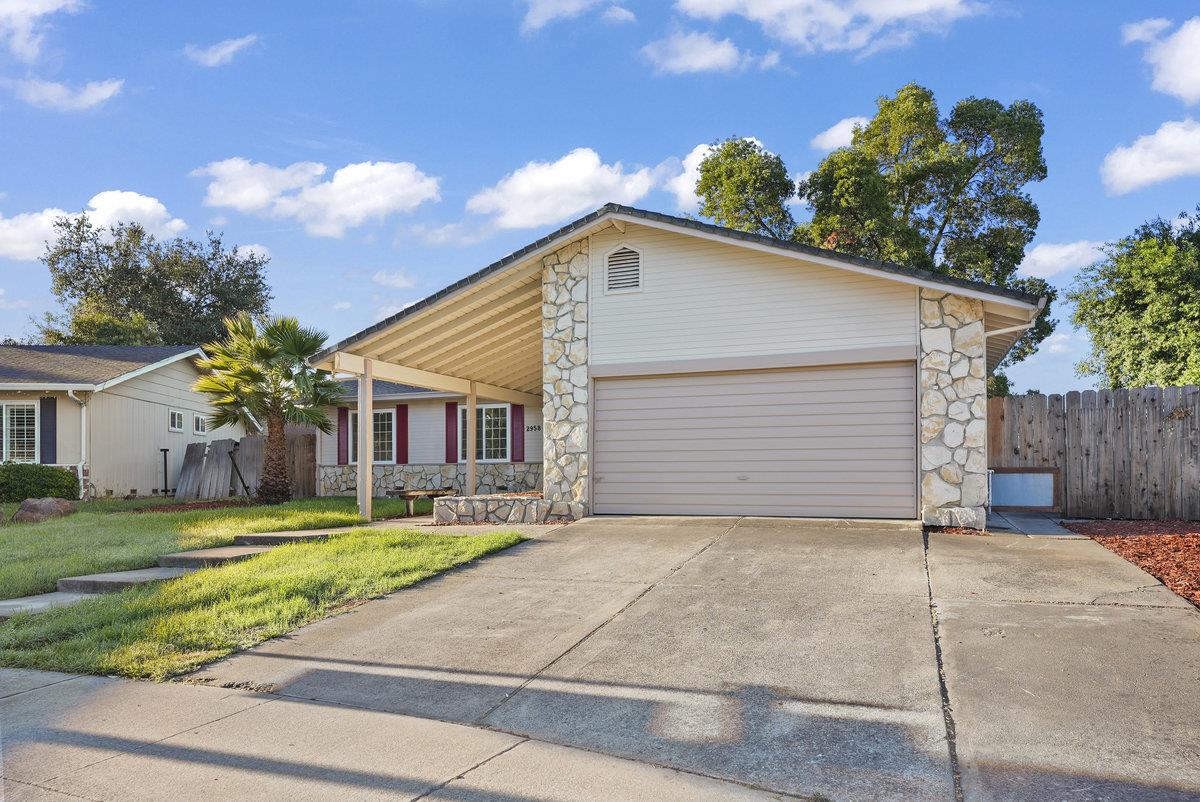 a view of a house with a yard and garage