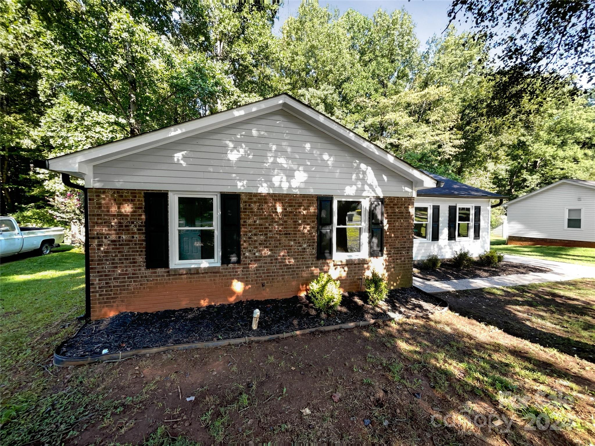 a front view of a house with garden