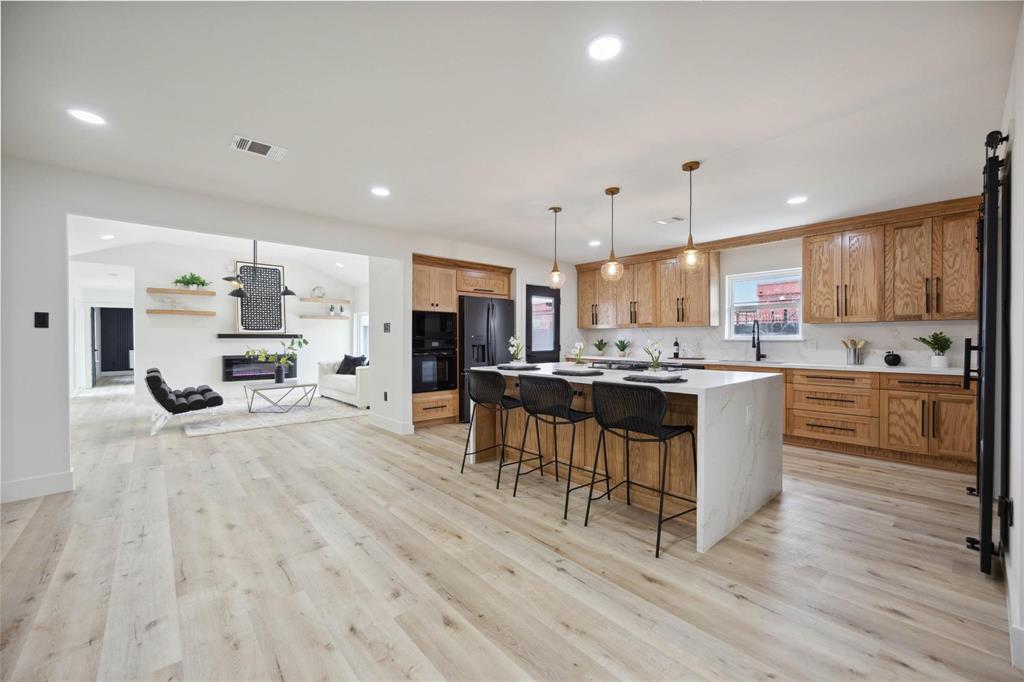 a kitchen with a sink cabinets and wooden floor