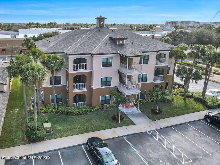 an aerial view of a house with a yard