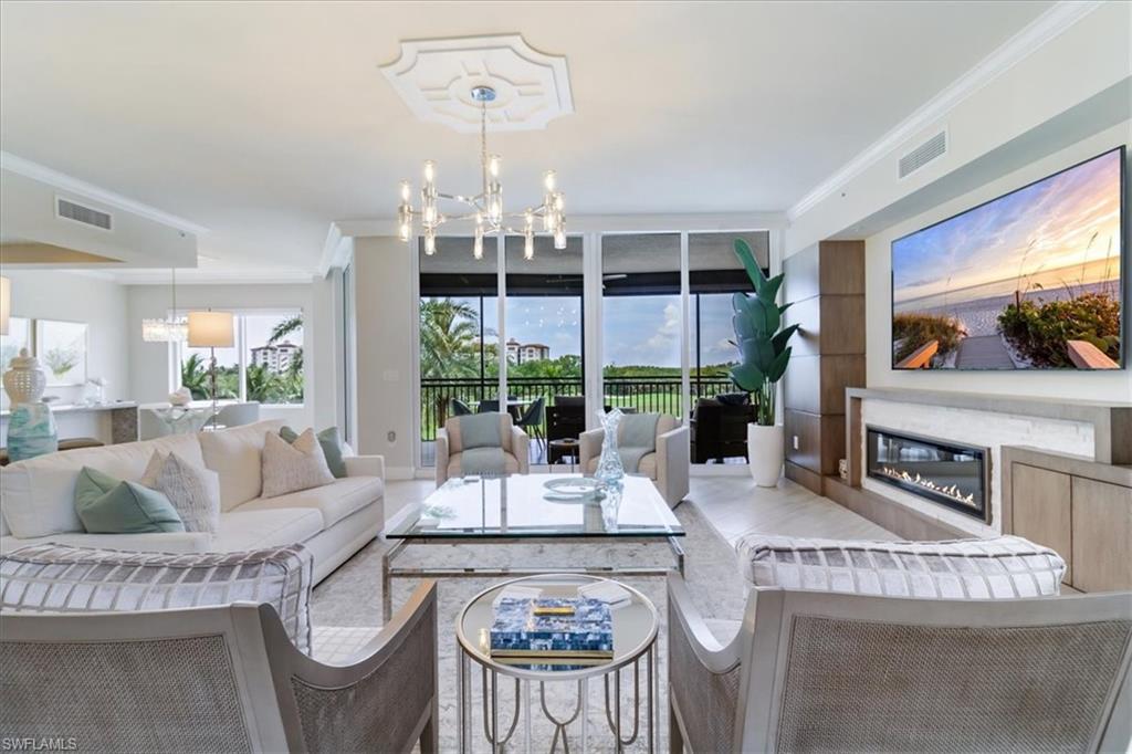 a living room with furniture and a chandelier