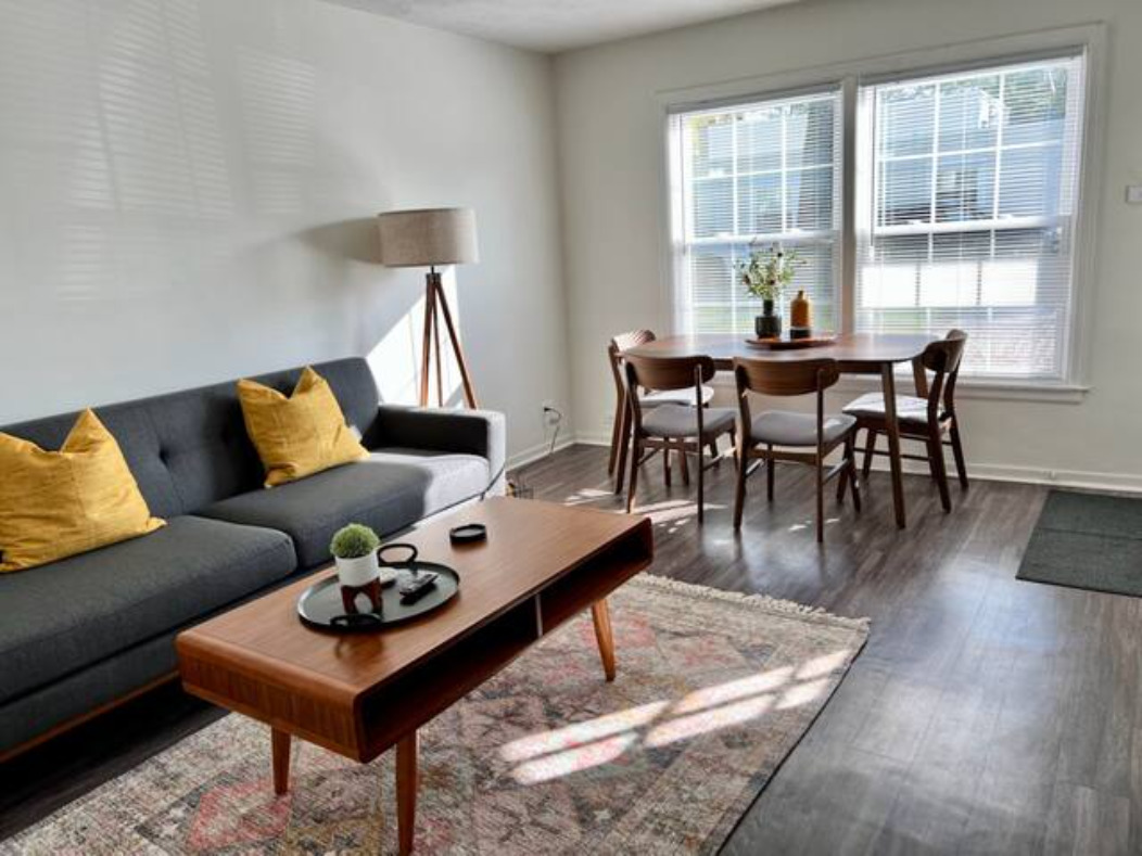 a living room with furniture and wooden floor