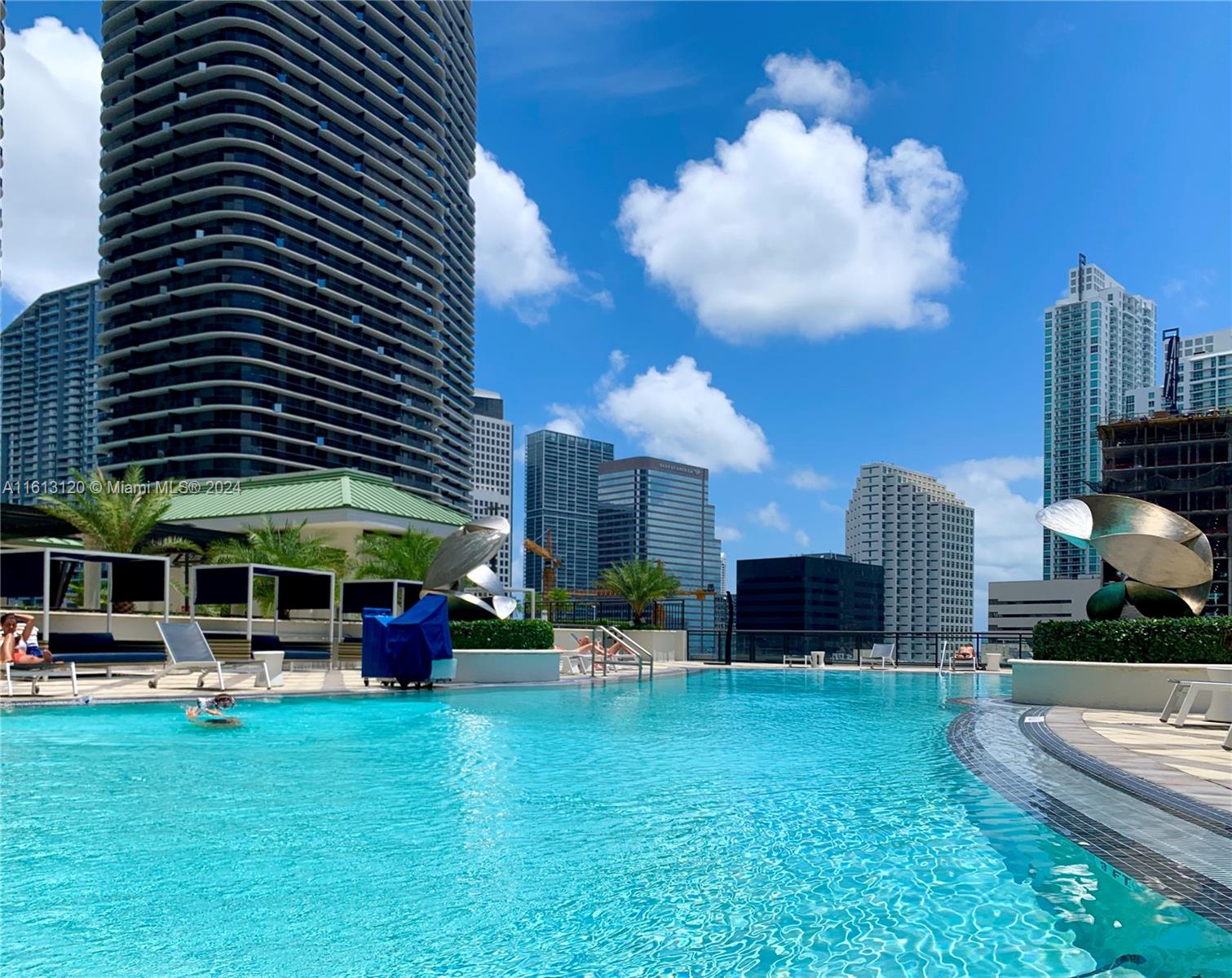 a swimming pool view with a seating space