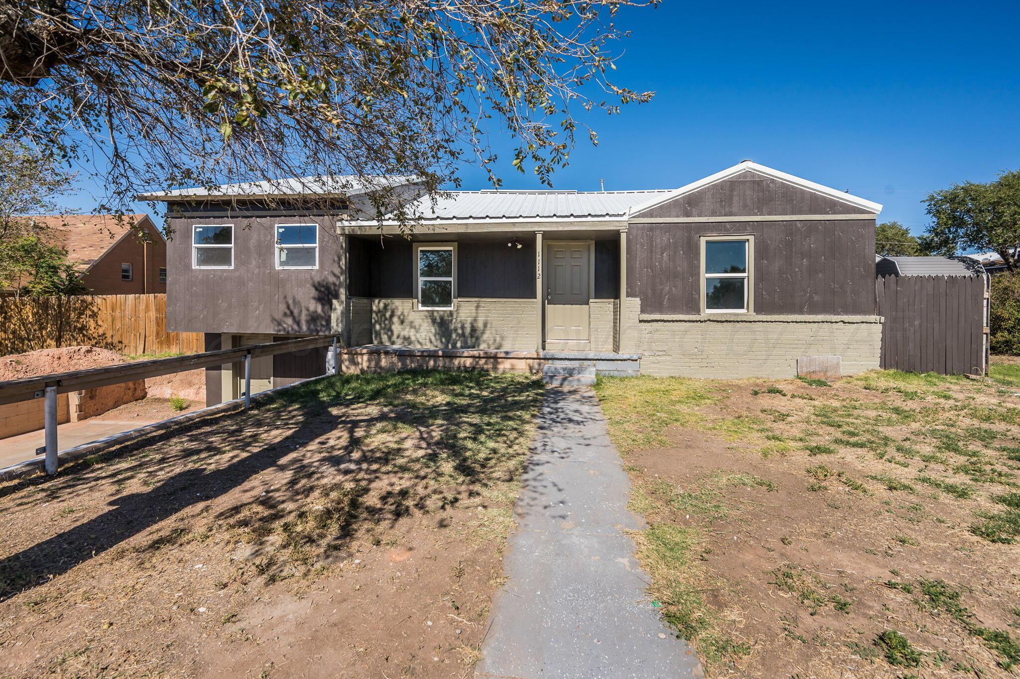 a front view of house with yard outdoor seating and barbeque oven