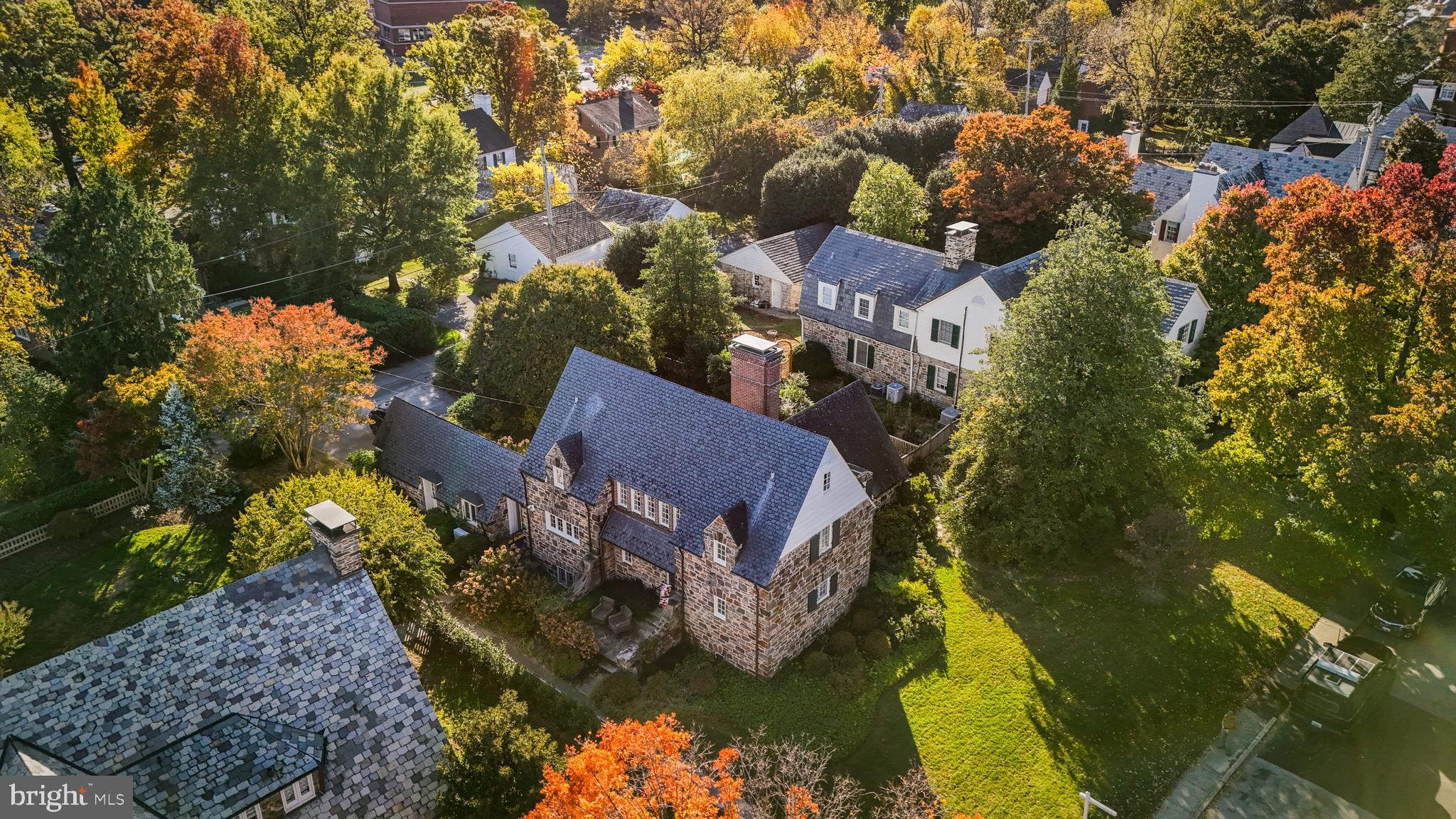 a aerial view of a house with a yard basket ball court and outdoor seating