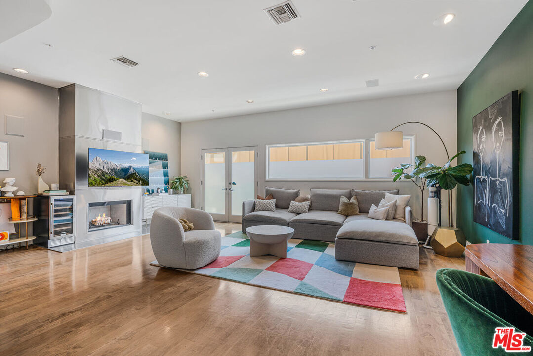 a living room with fireplace furniture and a large window