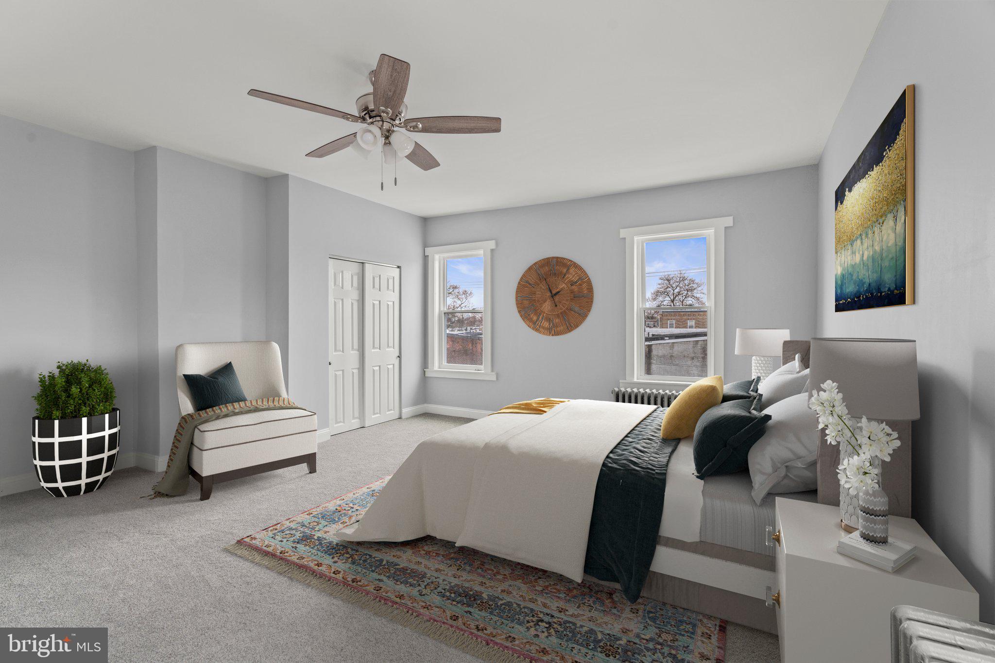 a bedroom with a bed and ceiling fan