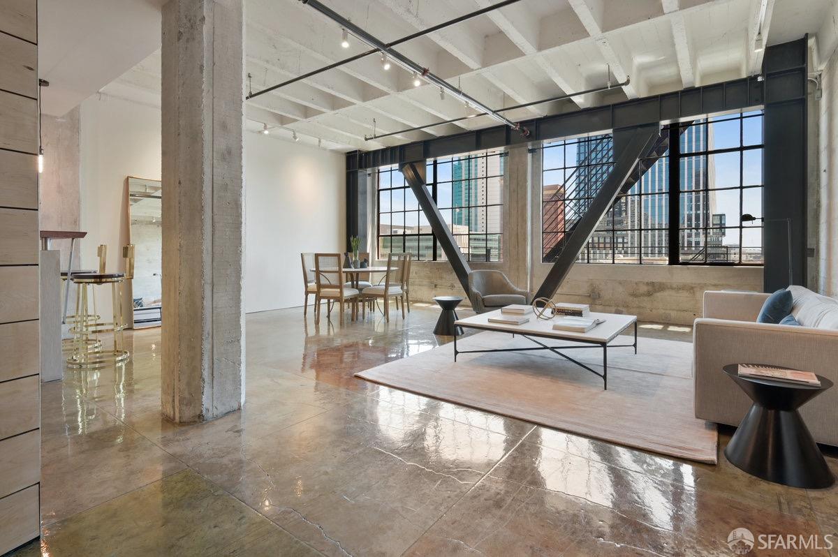 a view of living room with furniture and large windows