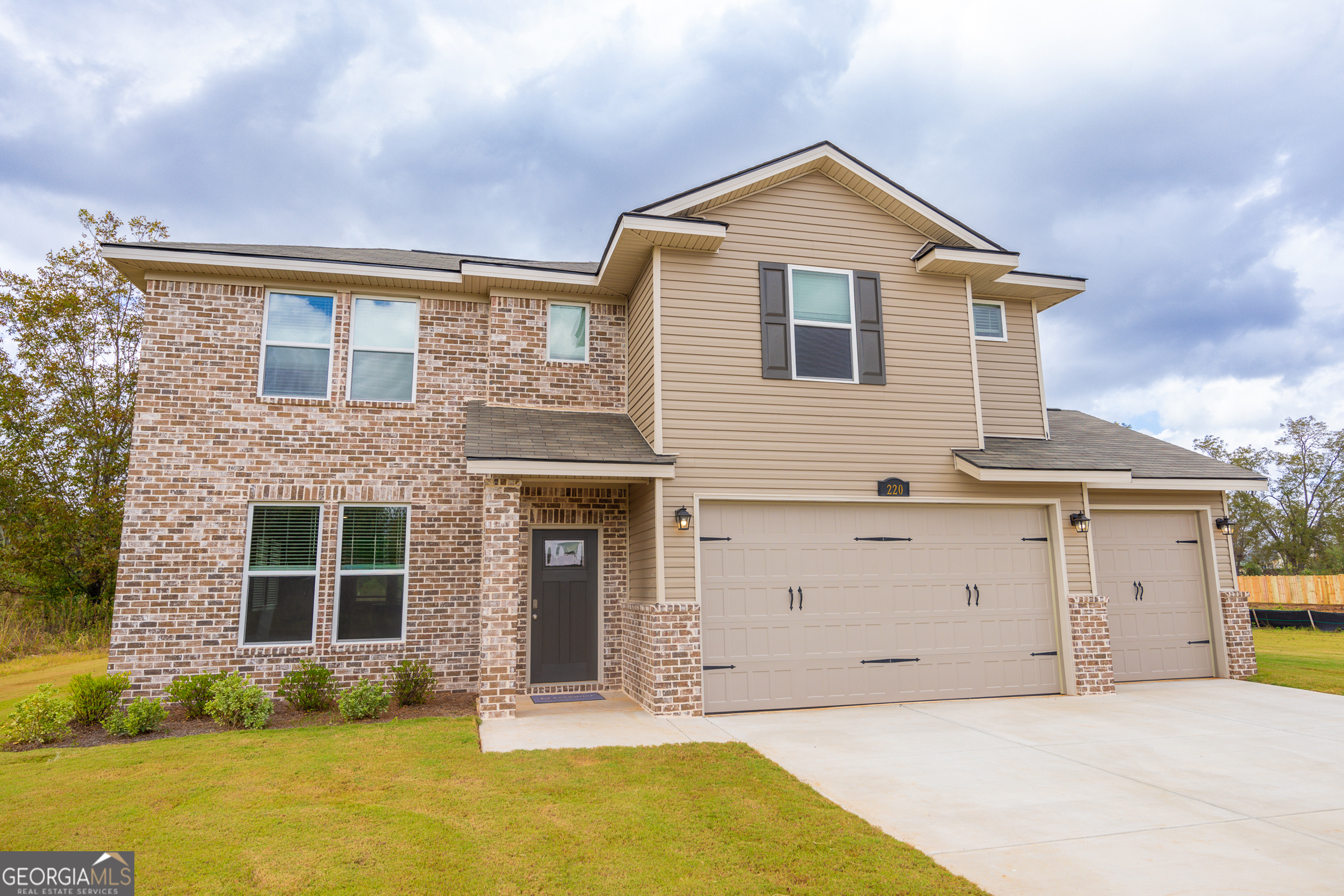 a front view of a house with a yard