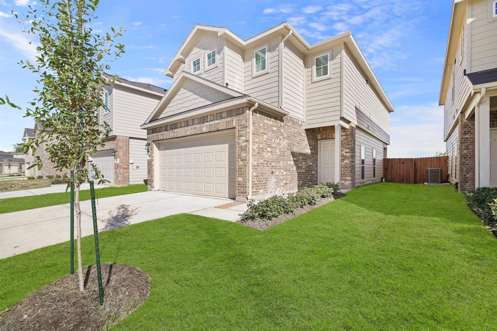 a view of a house with a yard and pathway