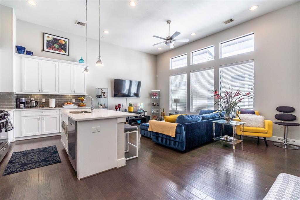 a view of living room with kitchen island furniture and a wooden floor