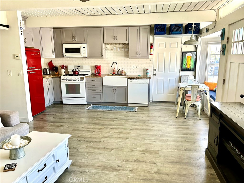 a kitchen with stainless steel appliances kitchen island granite countertop a sink and cabinets