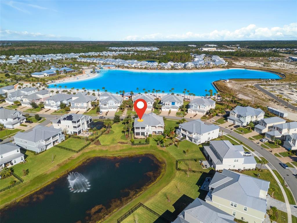 an aerial view of a swimming pool with outdoor seating