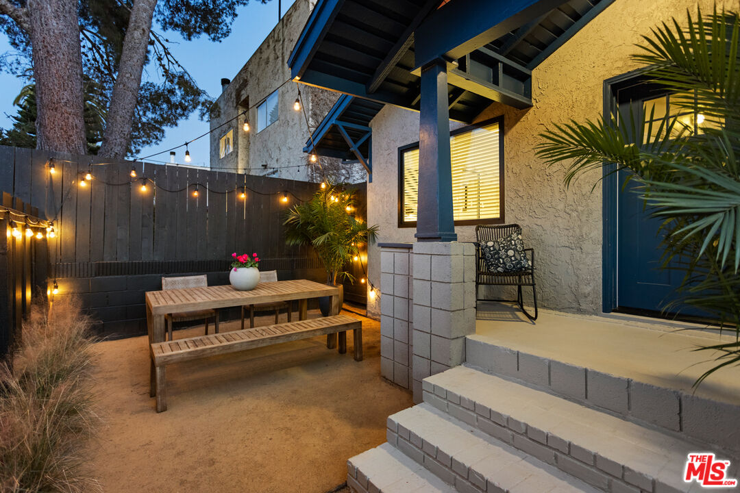 a building outdoor space with patio furniture and potted plants