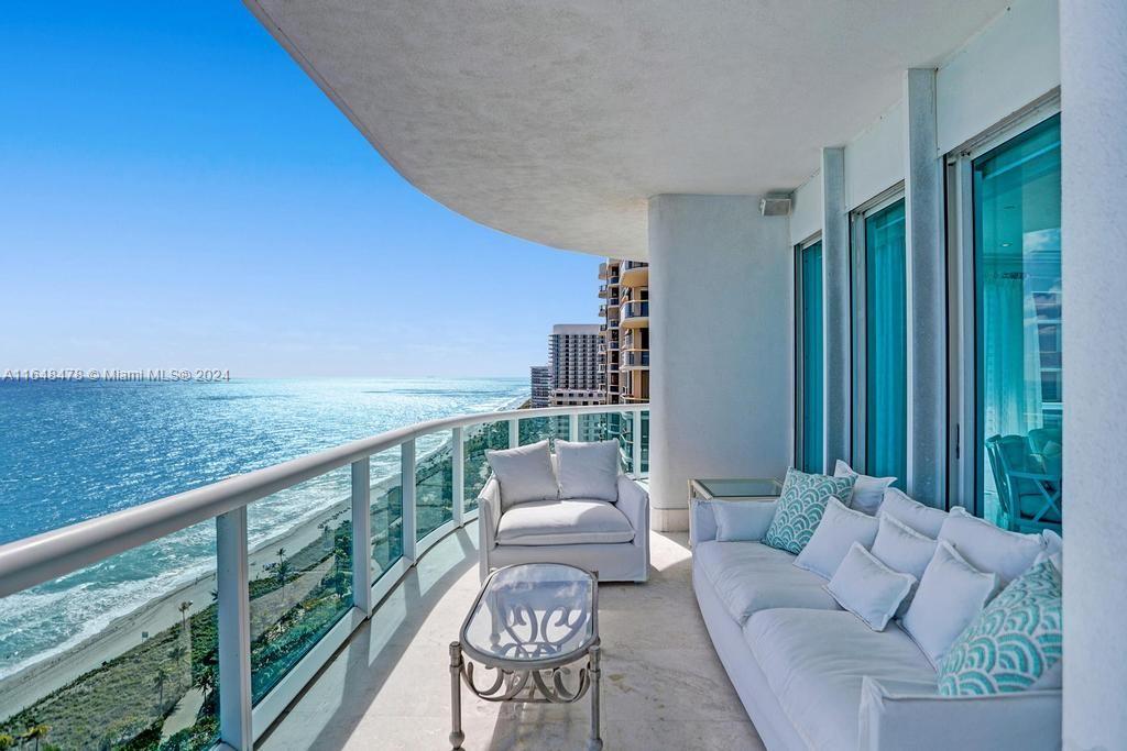 a balcony with furniture and garden view