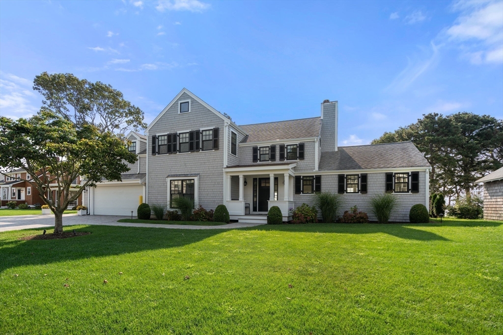 a front view of a house with a garden