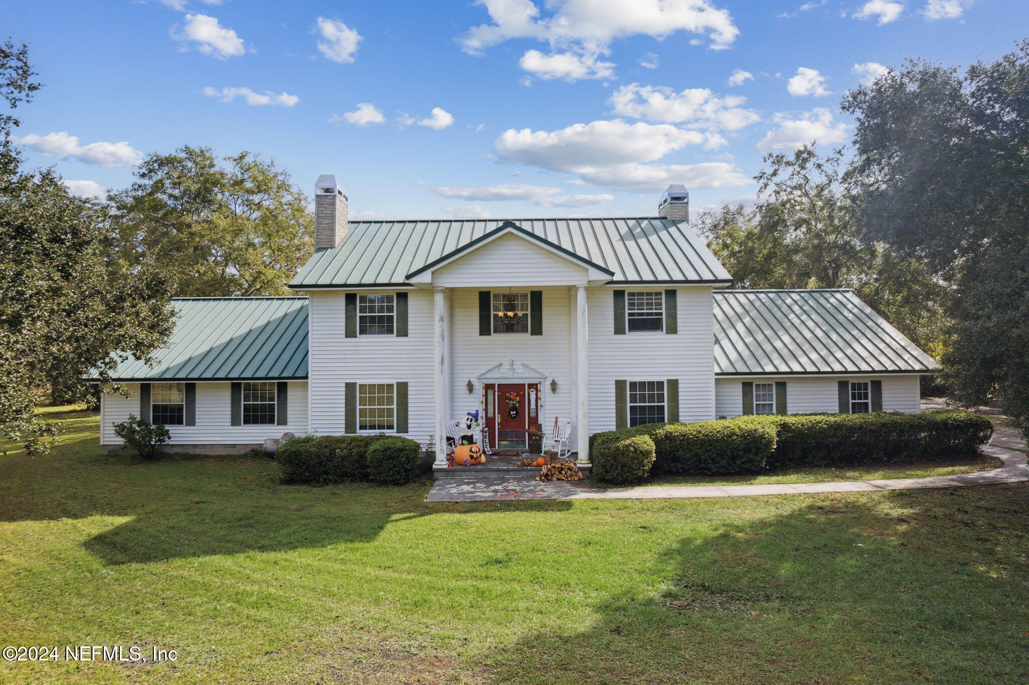 a front view of a house with a garden