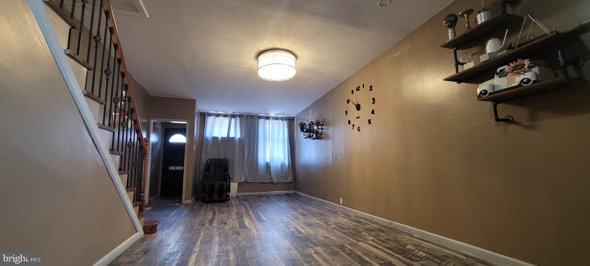 a view of hallway with wooden floor