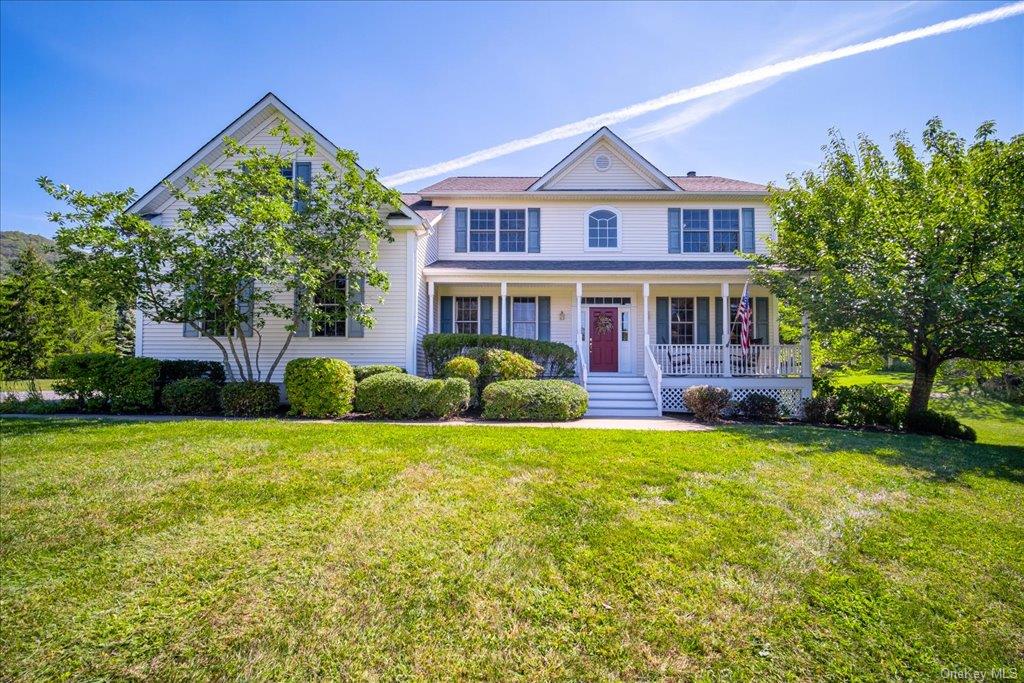 View of front of property featuring a front yard and a porch