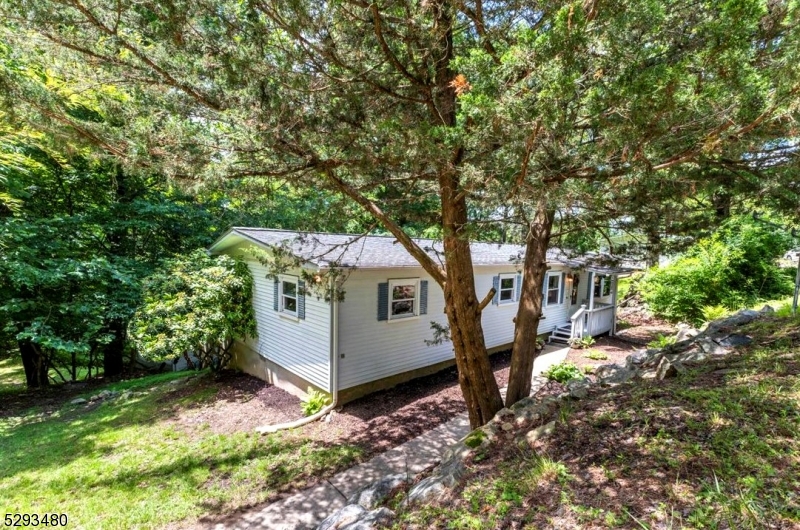 a view of a house with a tree and yard