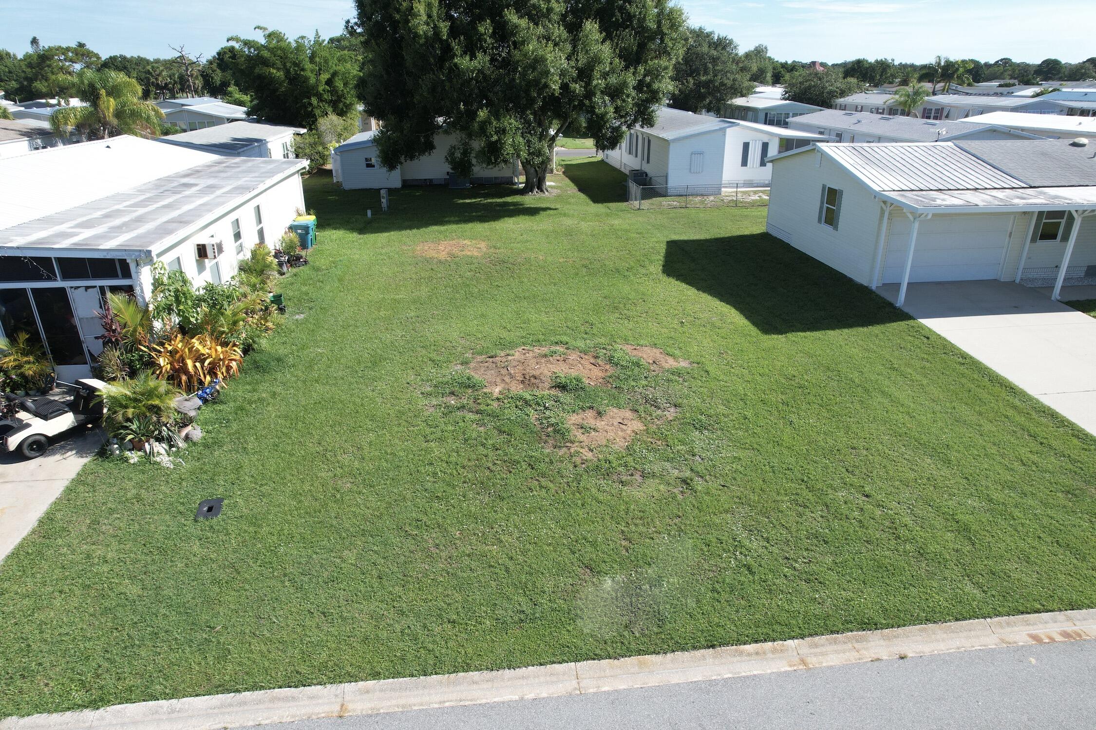 a aerial view of a house with yard and green space