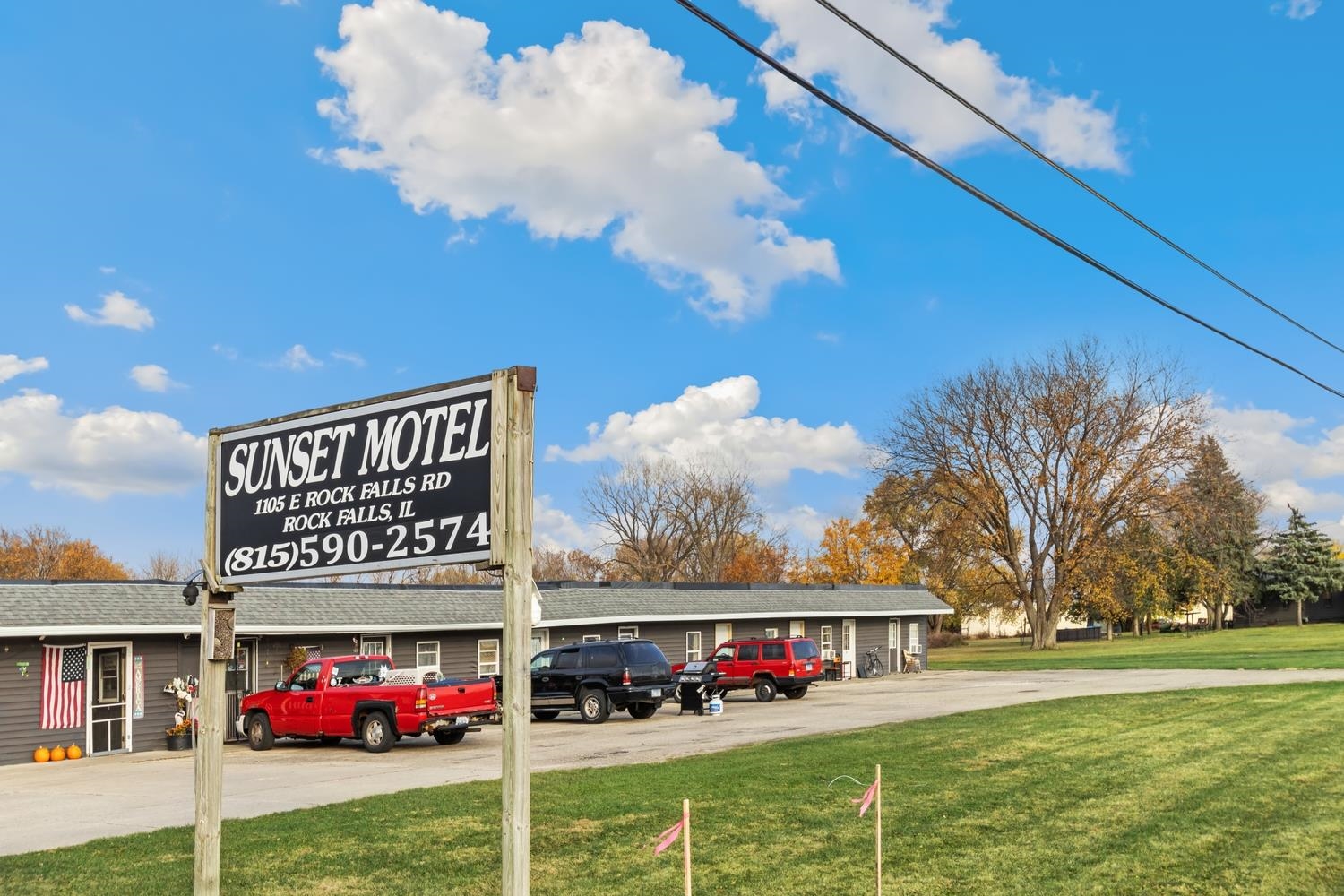 a sign board with buildings in the background