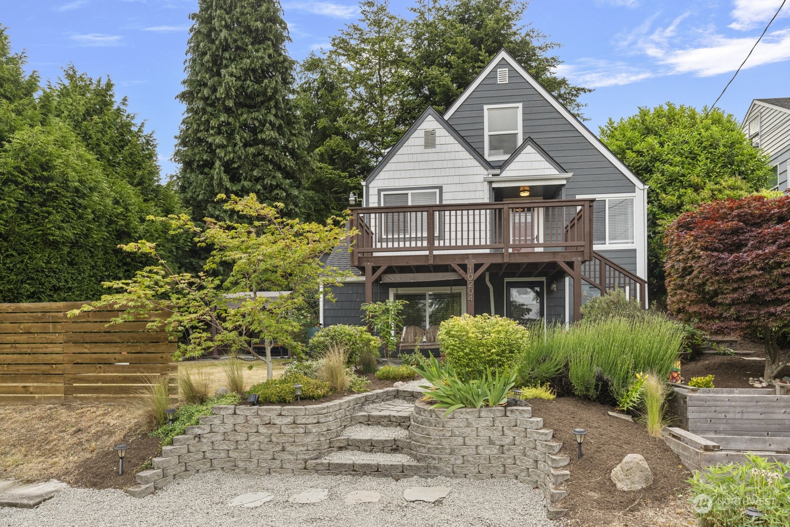 a front view of a house with a garden