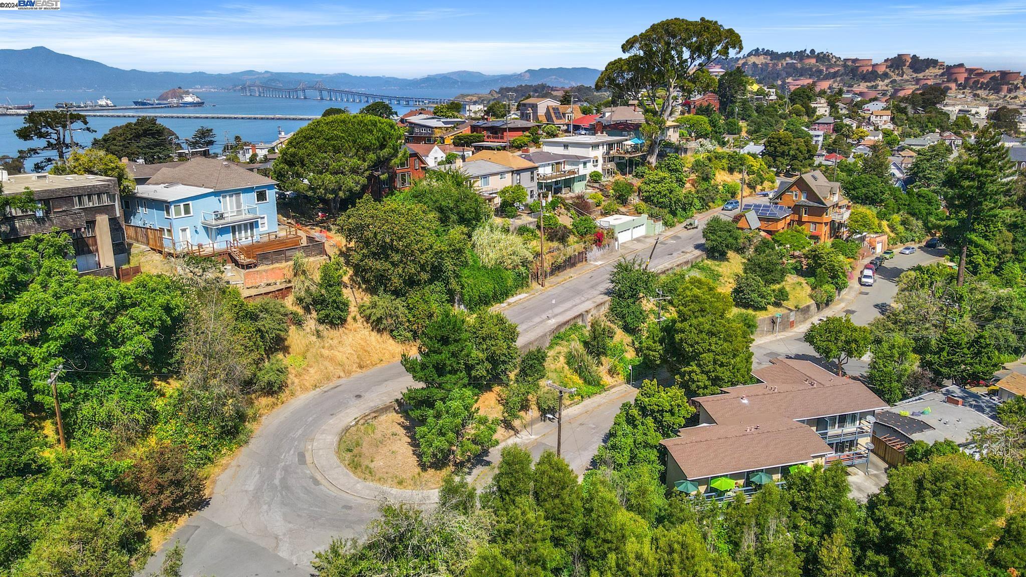 an aerial view of residential houses with outdoor space and street view