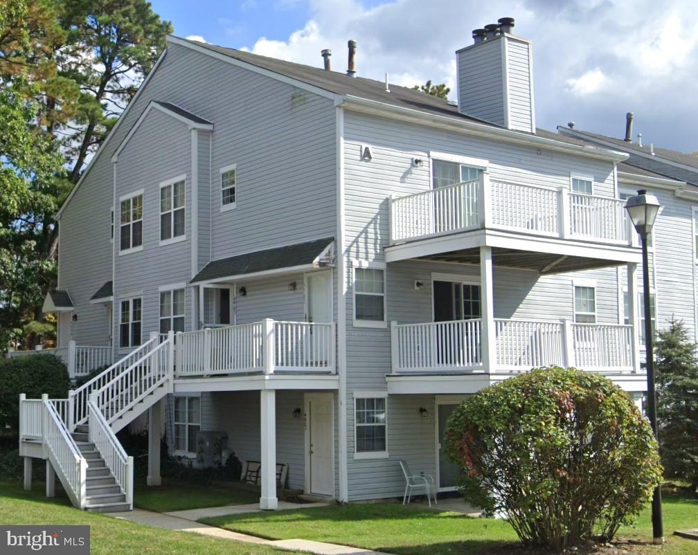 a front view of a residential apartment building with a yard