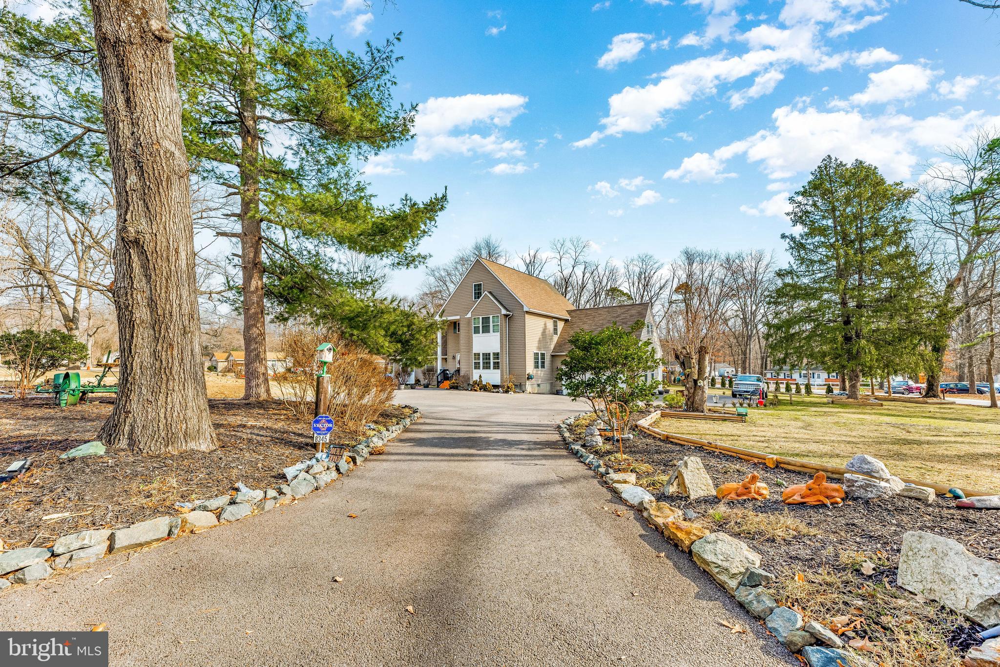 a view of a house with a yard and tree s