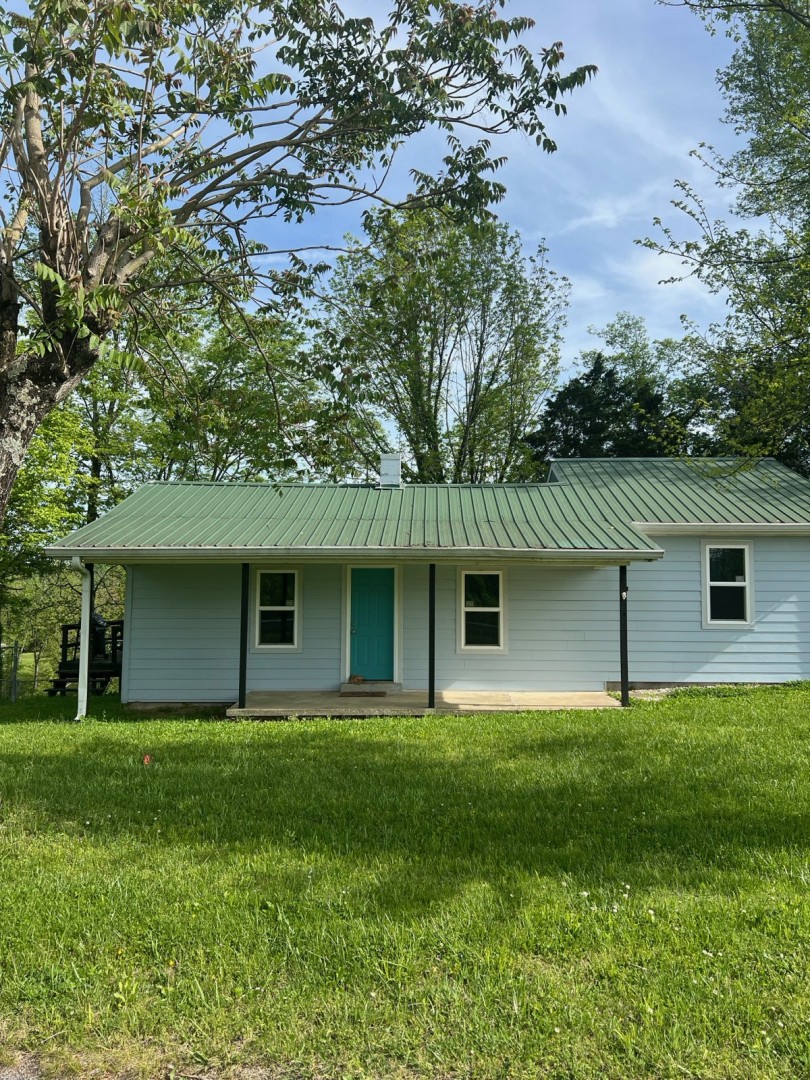 a house that has a tree in front of it