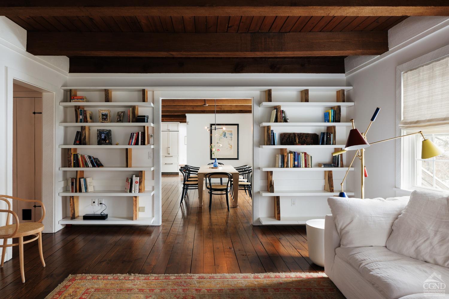 a living room with furniture and a book shelf