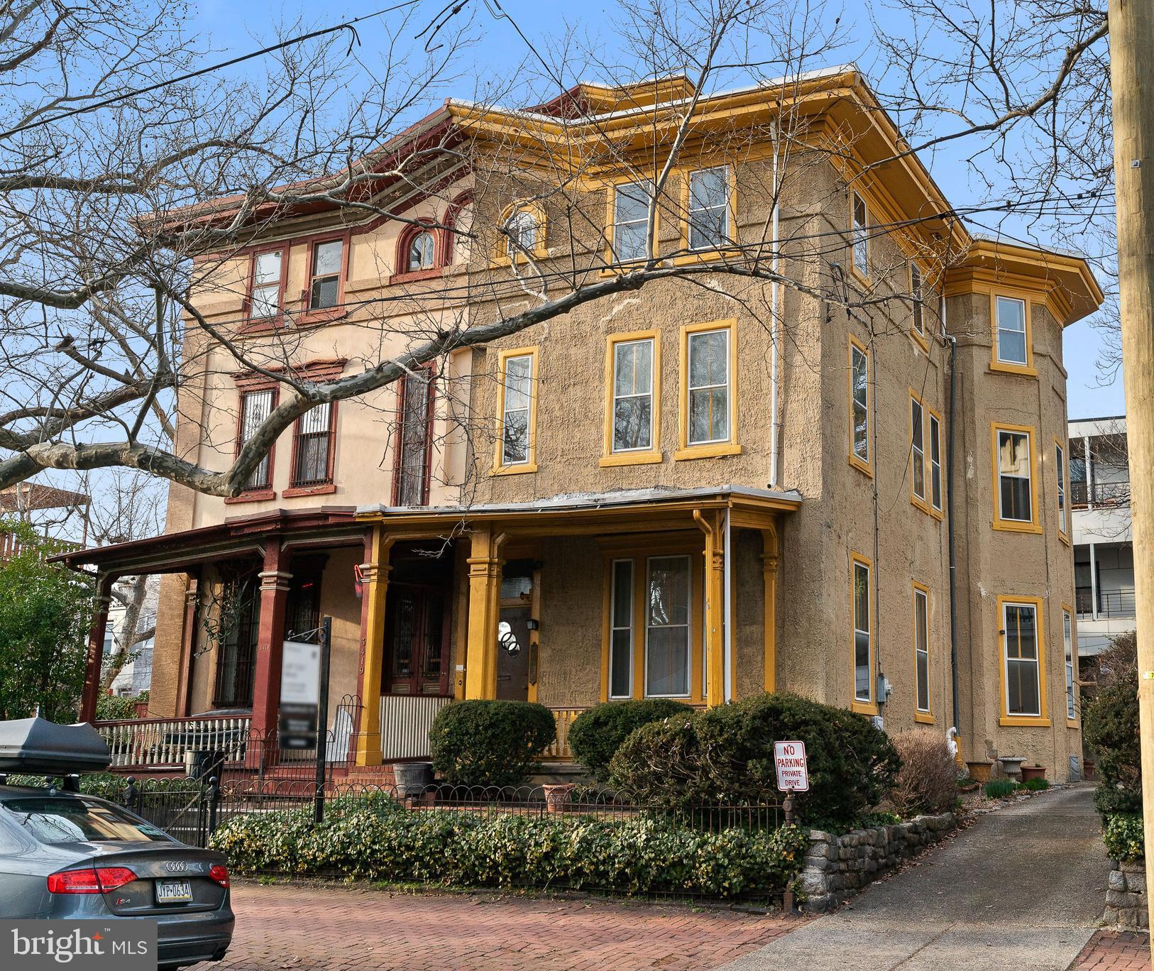 a front view of a residential apartment building with a yard