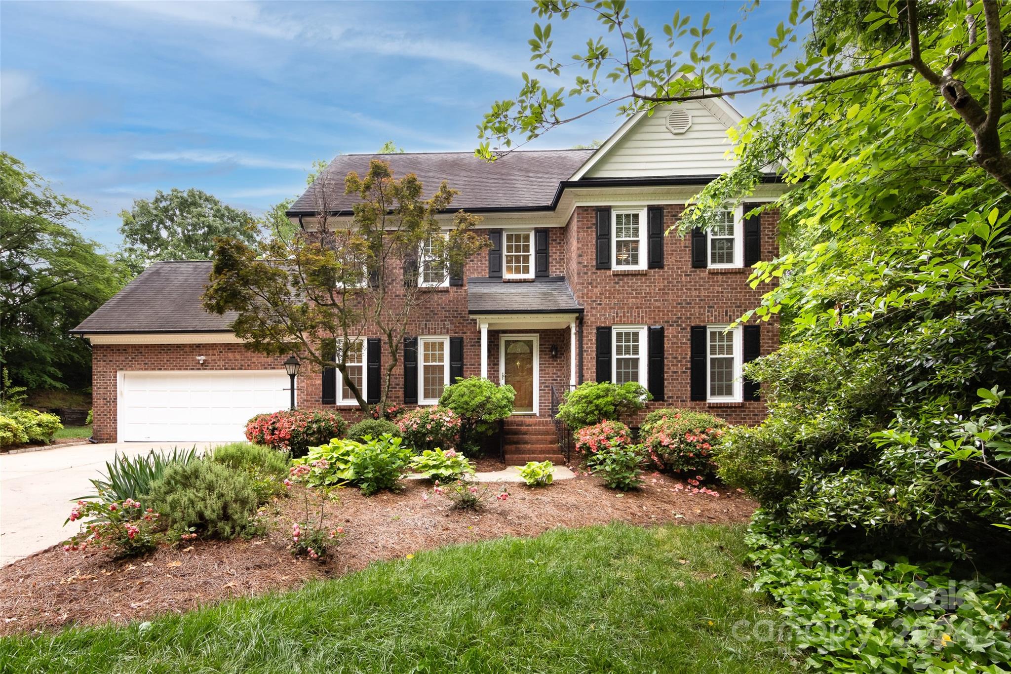 a front view of house with yard and green space