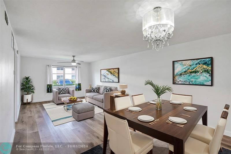 a view of a dining room with furniture wooden floor and a chandelier