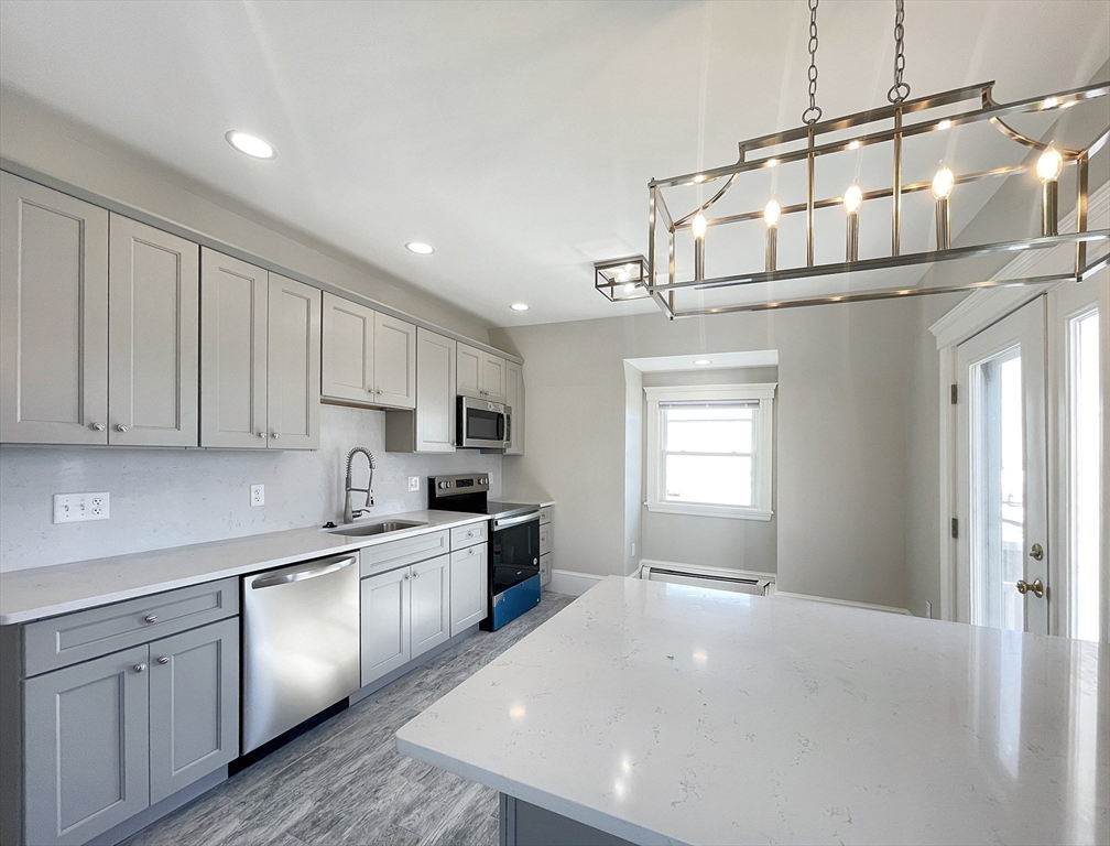 a kitchen with stainless steel appliances a refrigerator sink and cabinets