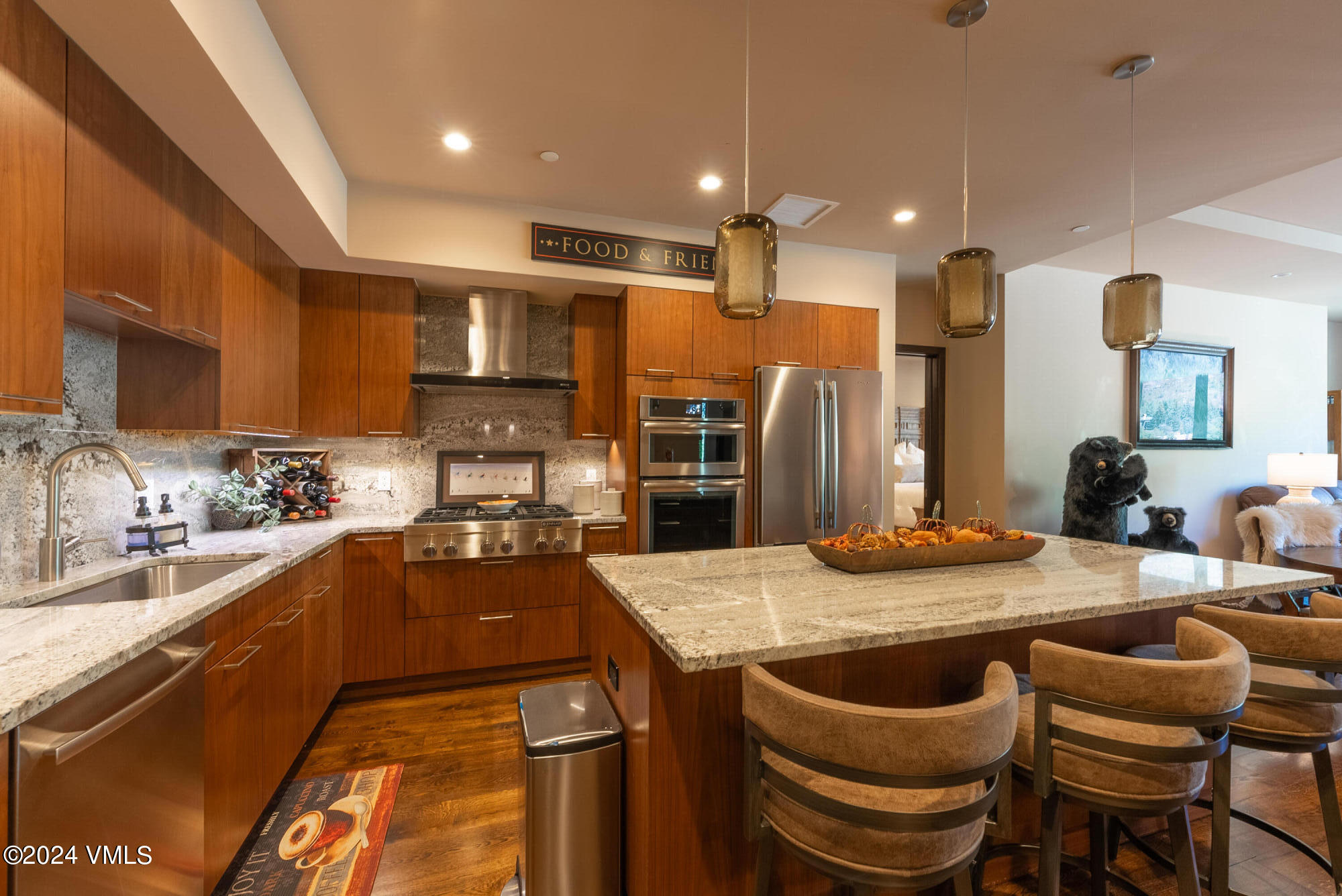 a kitchen with a sink a stove and chairs