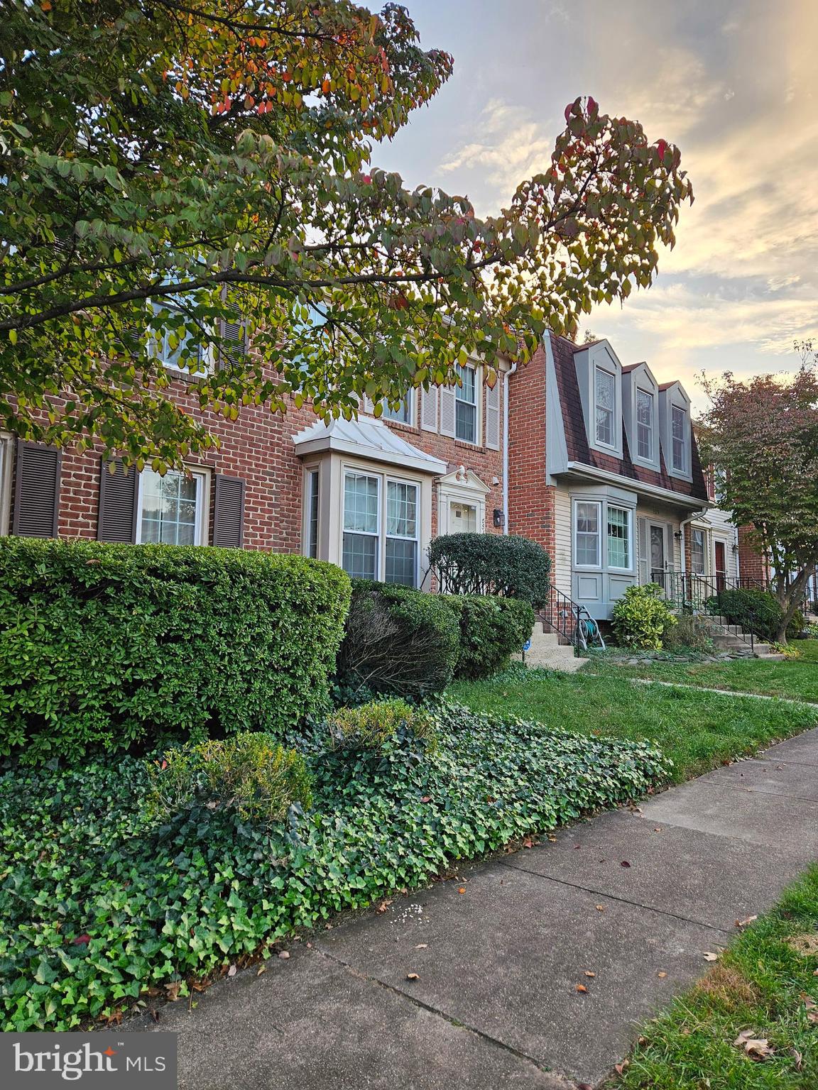 a view of a brick building next to a yard