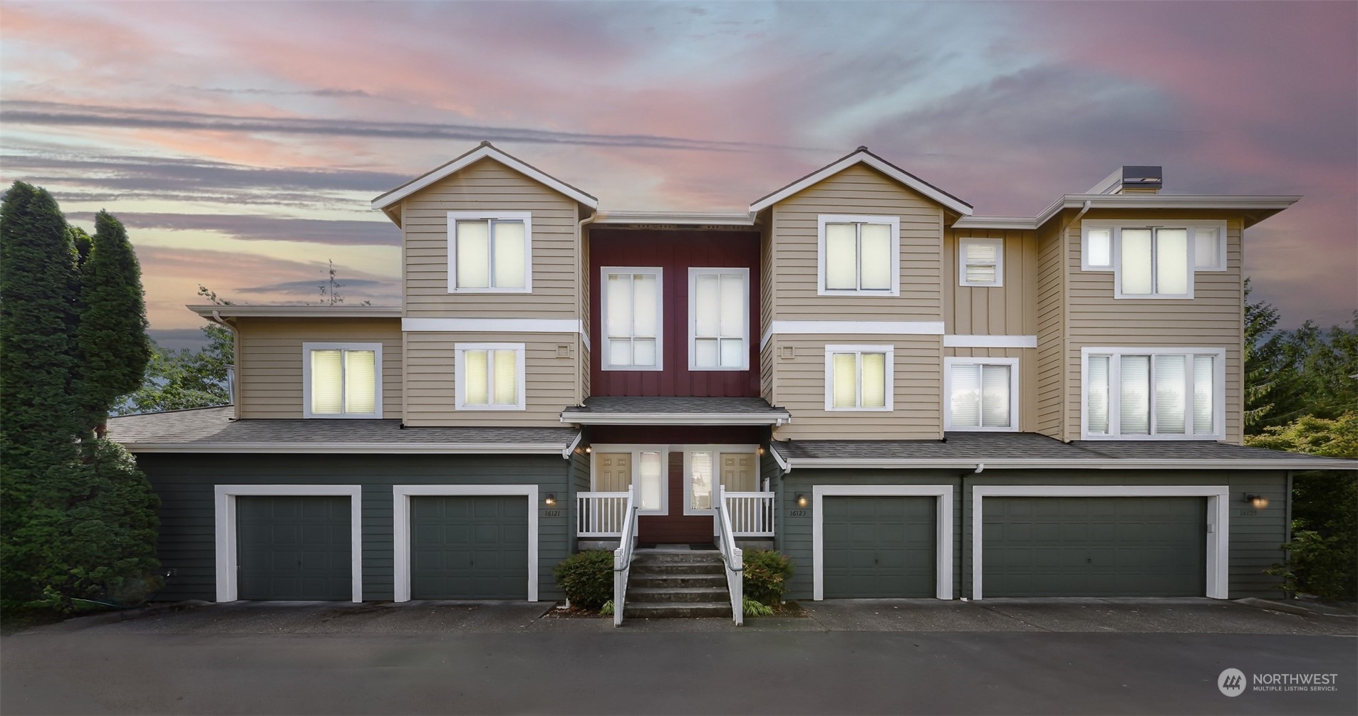 a front view of a residential apartment building with a garage