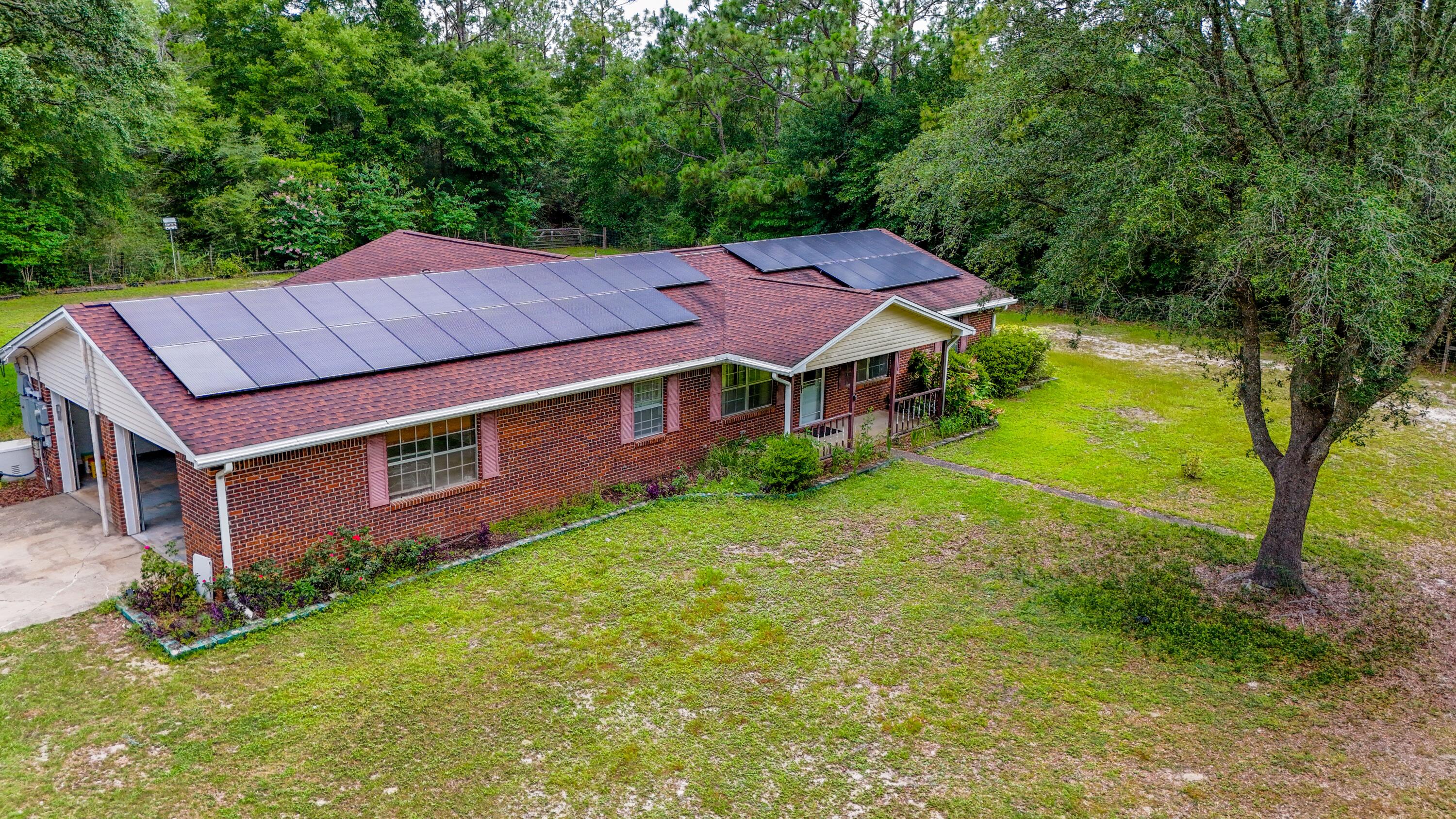 a aerial view of a house with a yard table and chairs