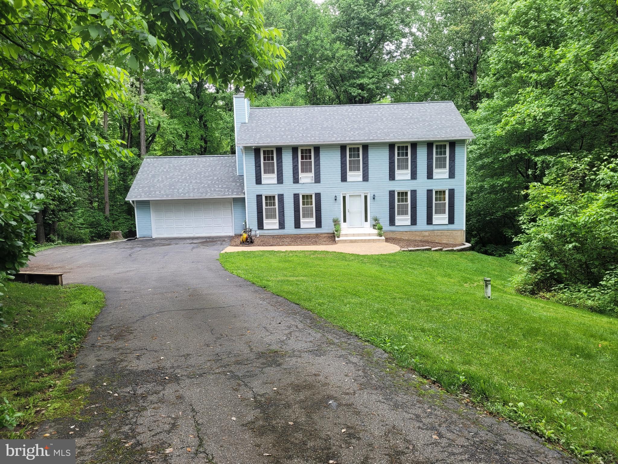 a view of a house with a yard and sitting area