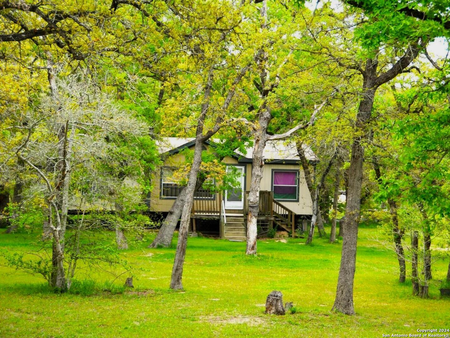 a view of a house with a backyard